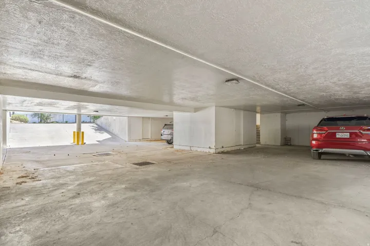 Covered underground parking structure with concrete flooring and heated ramp.  Includes storage area.