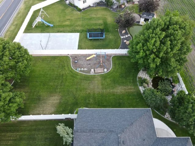 Side yard with play ground and pond