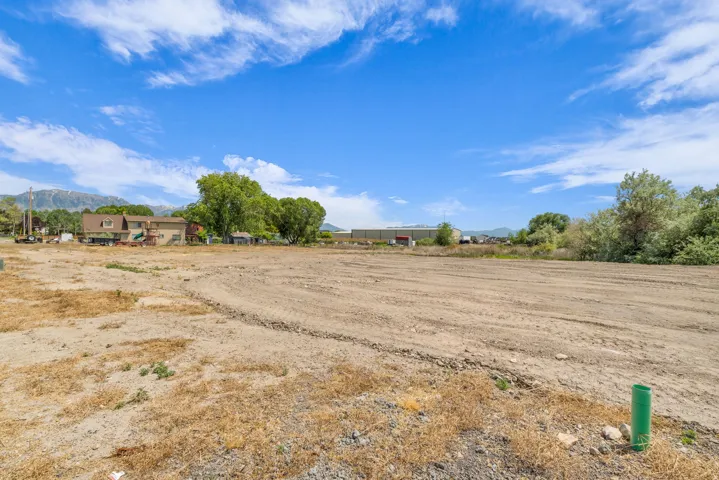 Expansive cleared lot with mountain backdrop