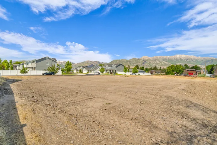 Expansive cleared lot with a level grade, offering a ready-to-build site