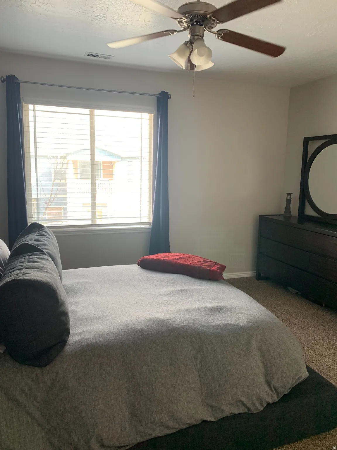 Neutral tone walls with a ceiling fan featuring three light fixtures