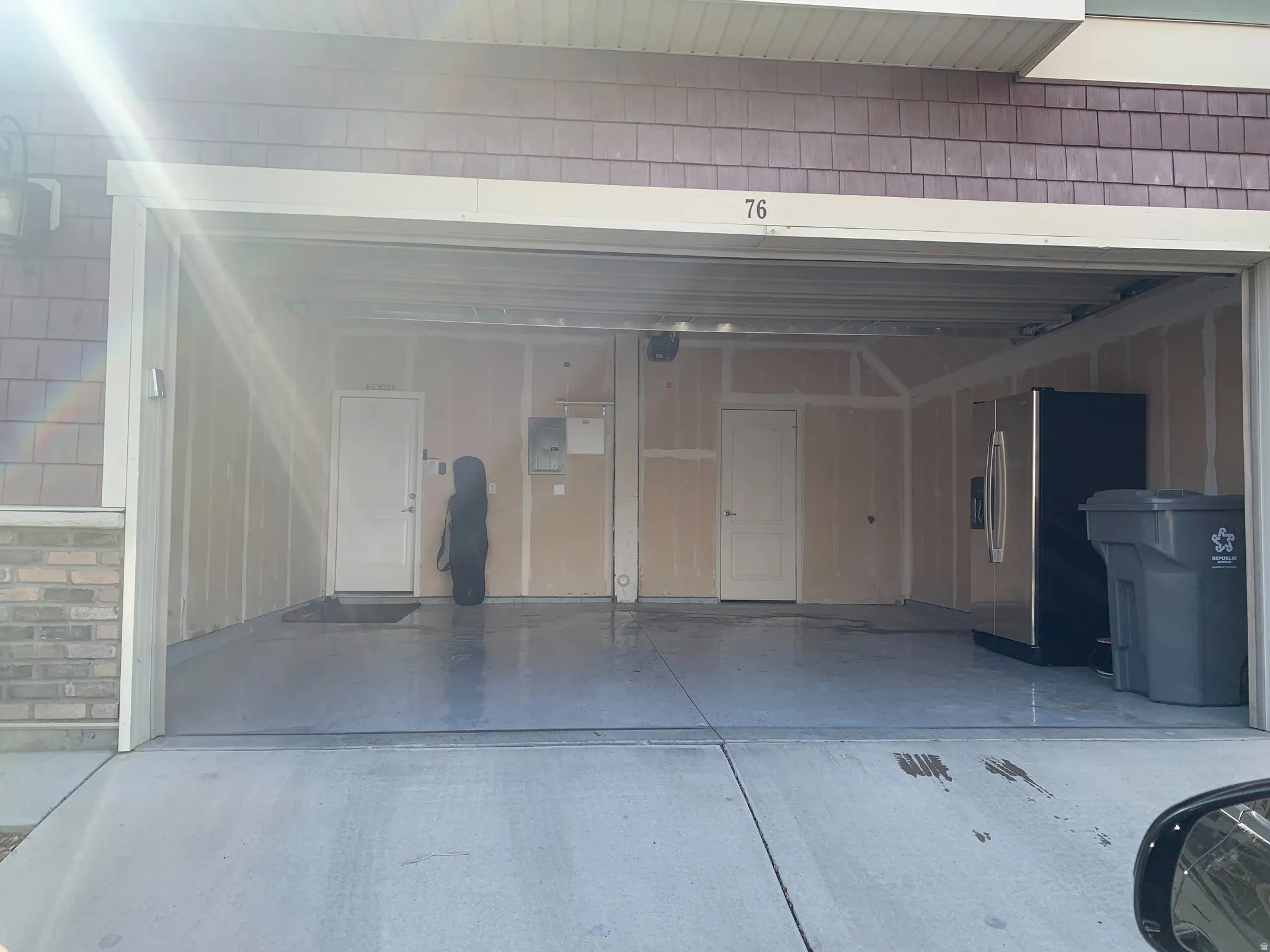 Two-car garage with unfinished walls, a concrete floor, and two interior access doors