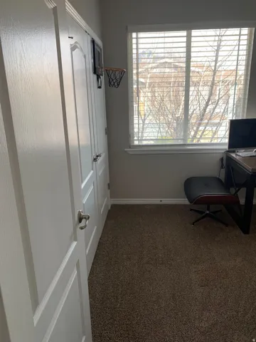 Neutral wall paint with textured carpet flooring