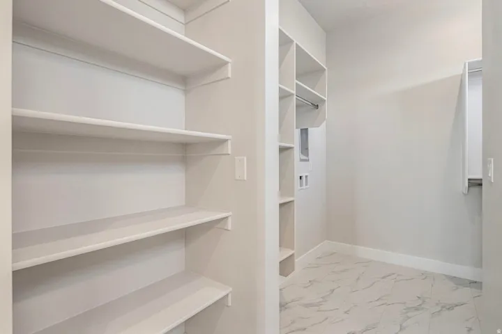 Main floor primary closet with laundry hookup