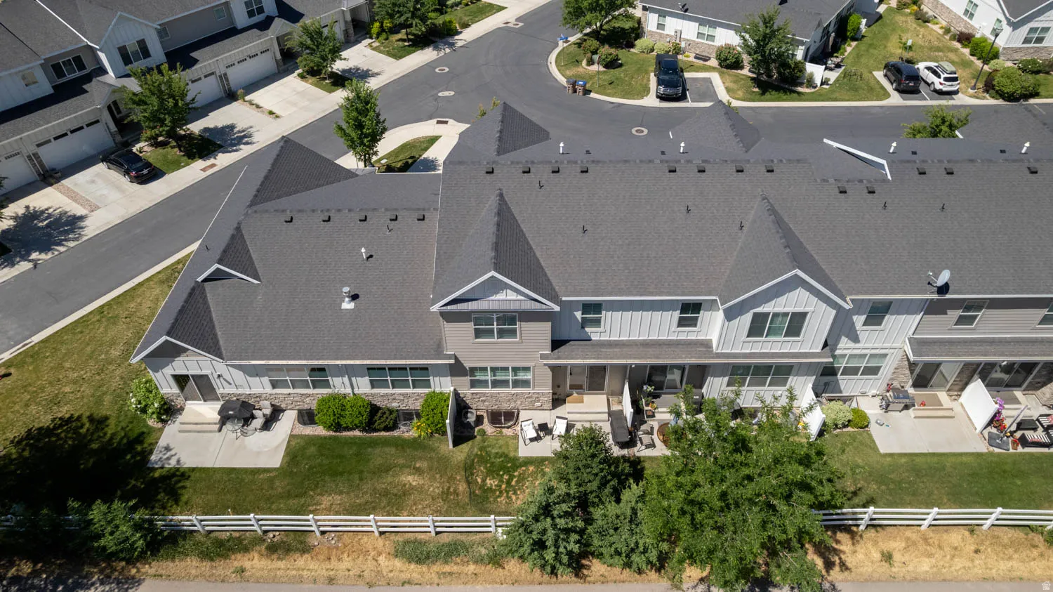 Contemporary townhome row featuring gabled roofs and varied siding textures