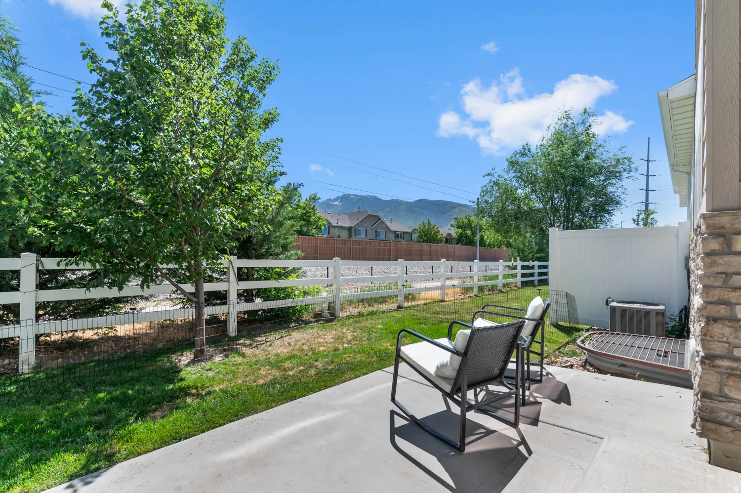 Concrete patio area with a stone veneer exterior wall