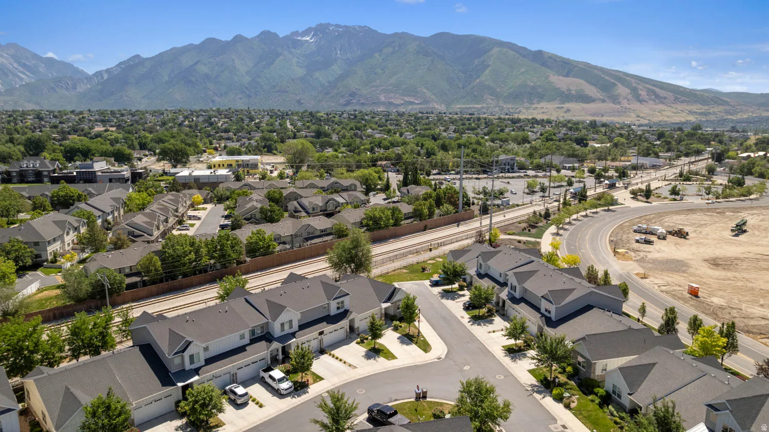 Aerial perspective showcasing residential properties with a mountainous backdrop