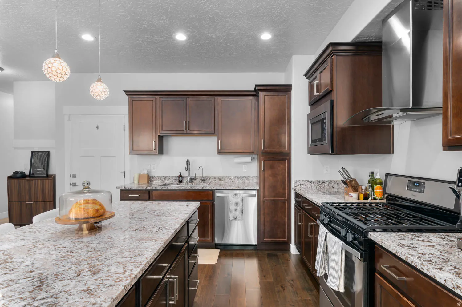 Modern kitchen with wood-finish flooring and extensive brown cabinetry