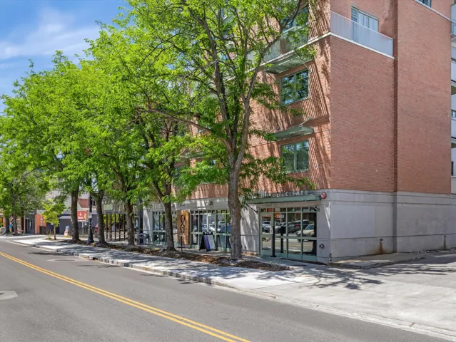 Brick commercial building with multiple storefronts and upper-level units