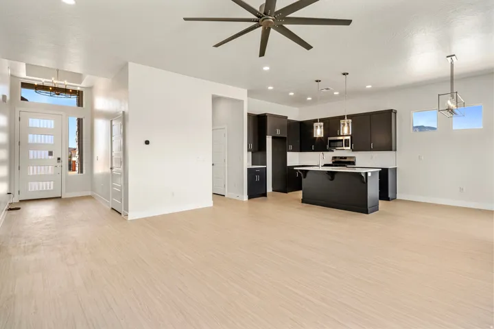 Open-concept living area with light wood-finish flooring