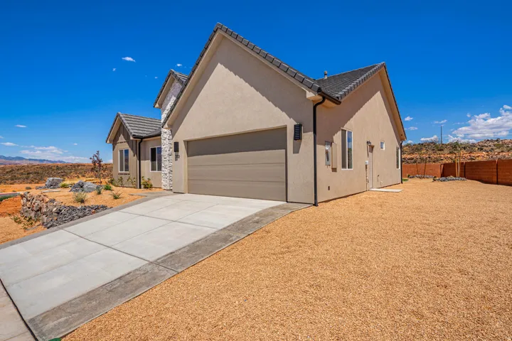 Contemporary stucco exterior with stone veneer accents