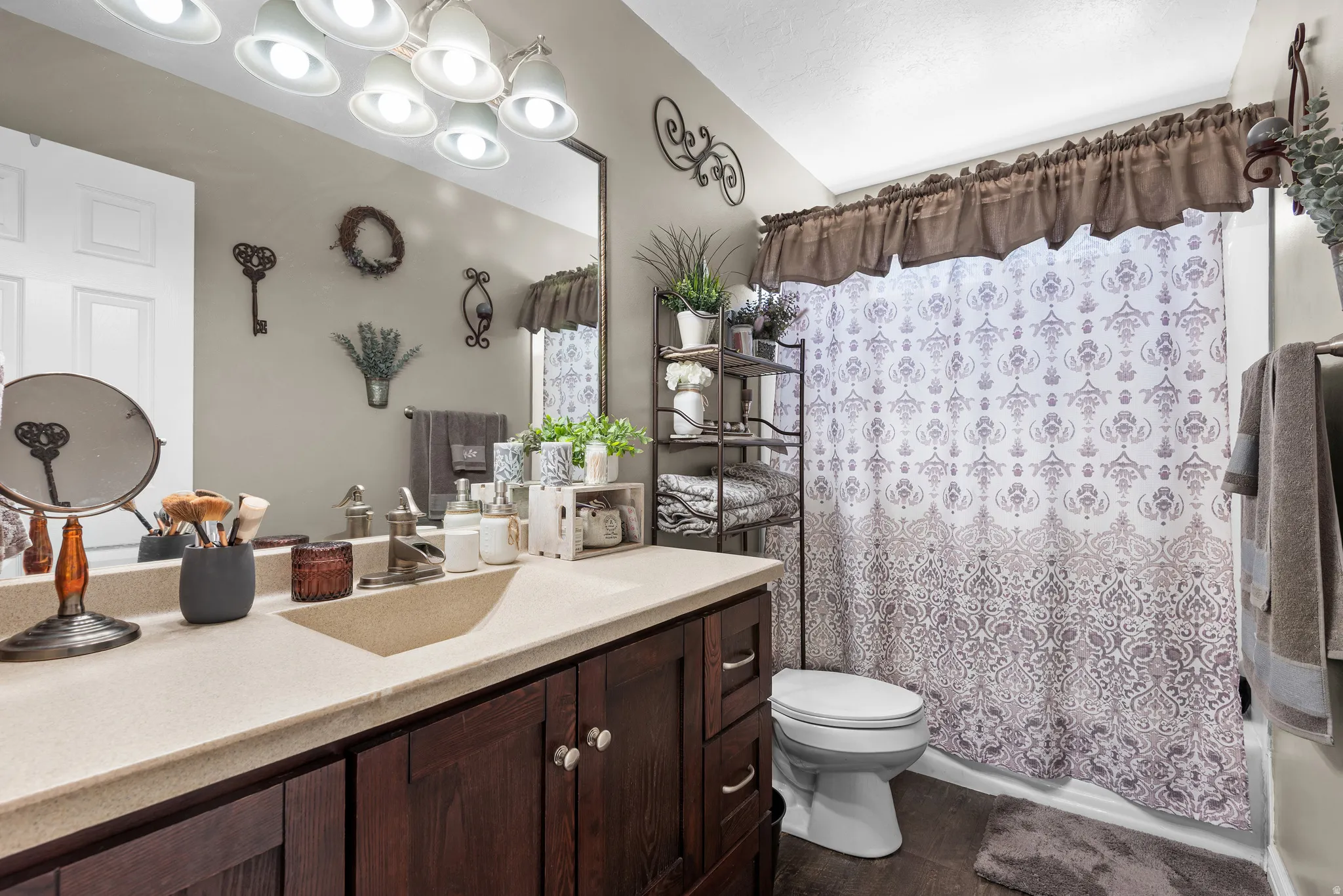 Bathroom featuring a vanity with a light-toned countertop and dark wood-finish cabinetry
