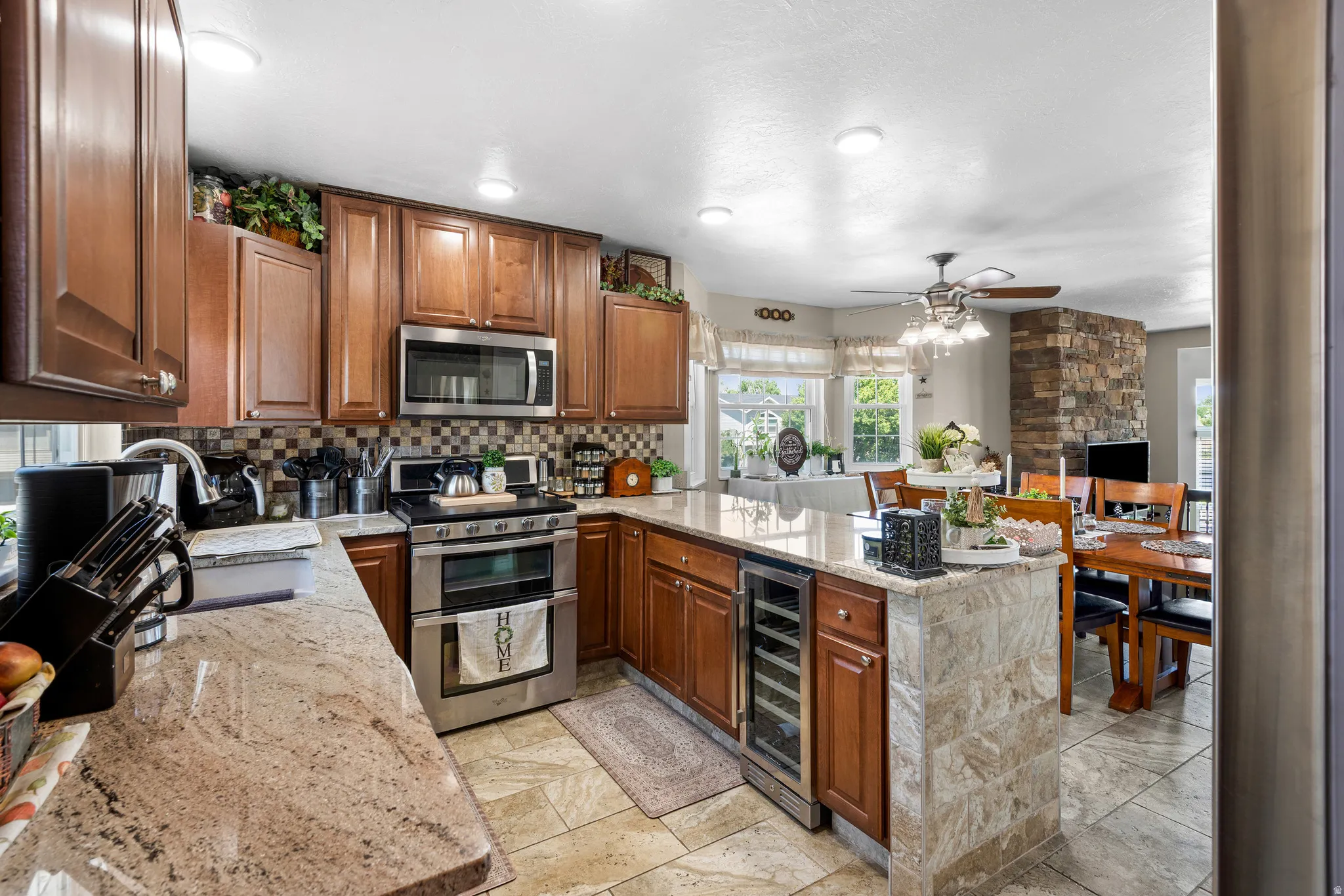 Well-appointed kitchen featuring wood cabinetry, granite countertops, and stainless steel appliances