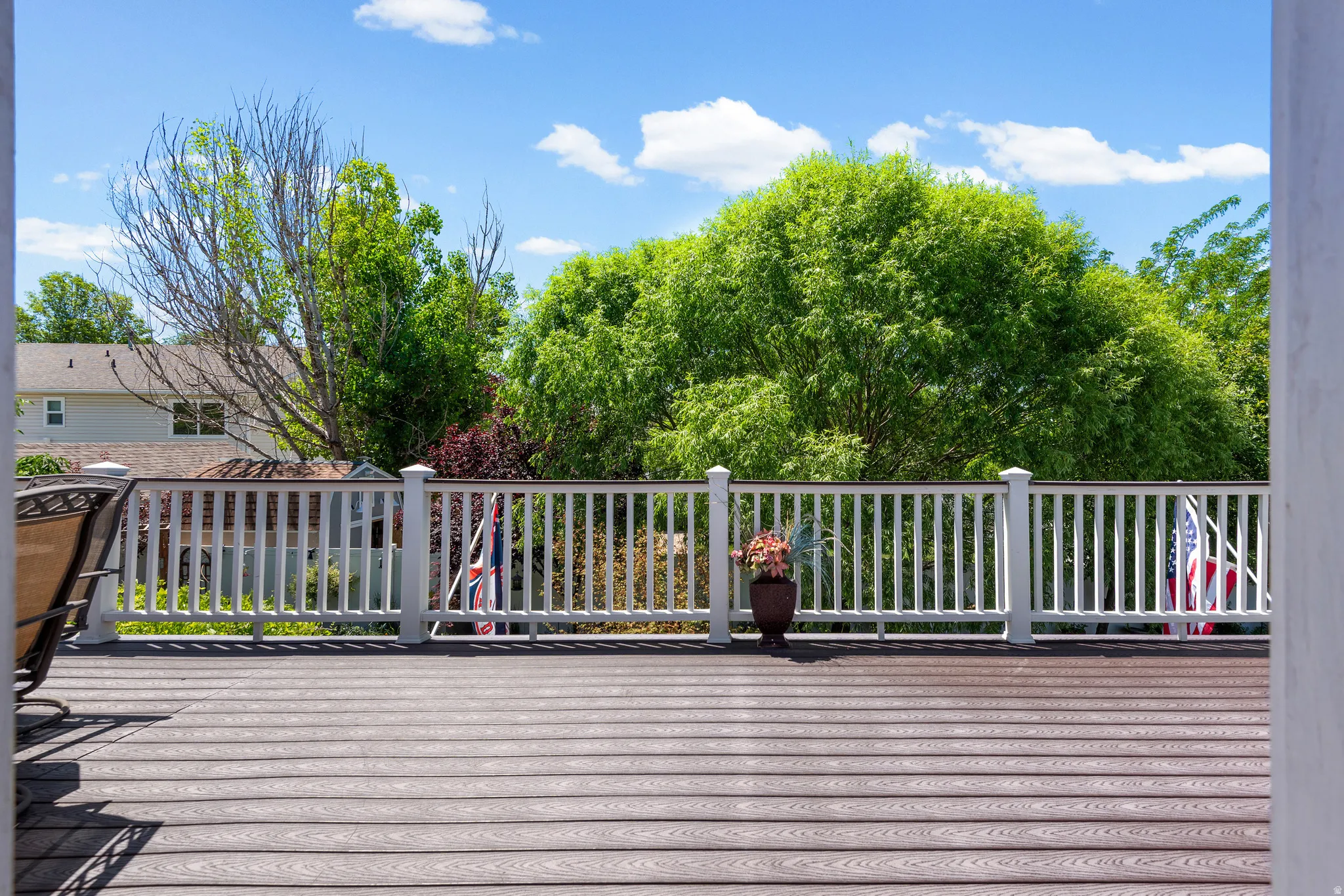 Spacious outdoor deck featuring composite decking and a white railing system