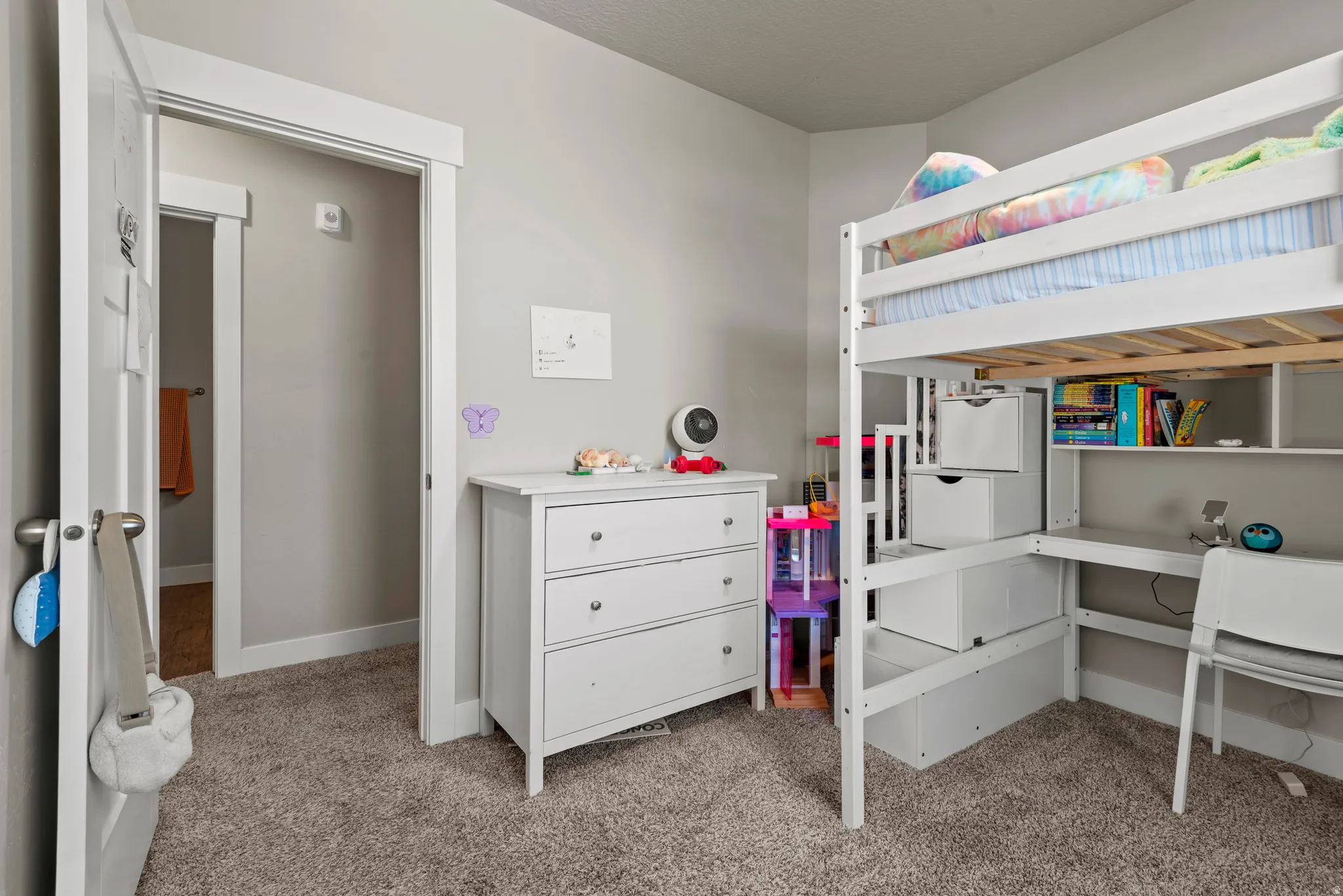Carpeted room featuring light gray wall paint and white baseboards