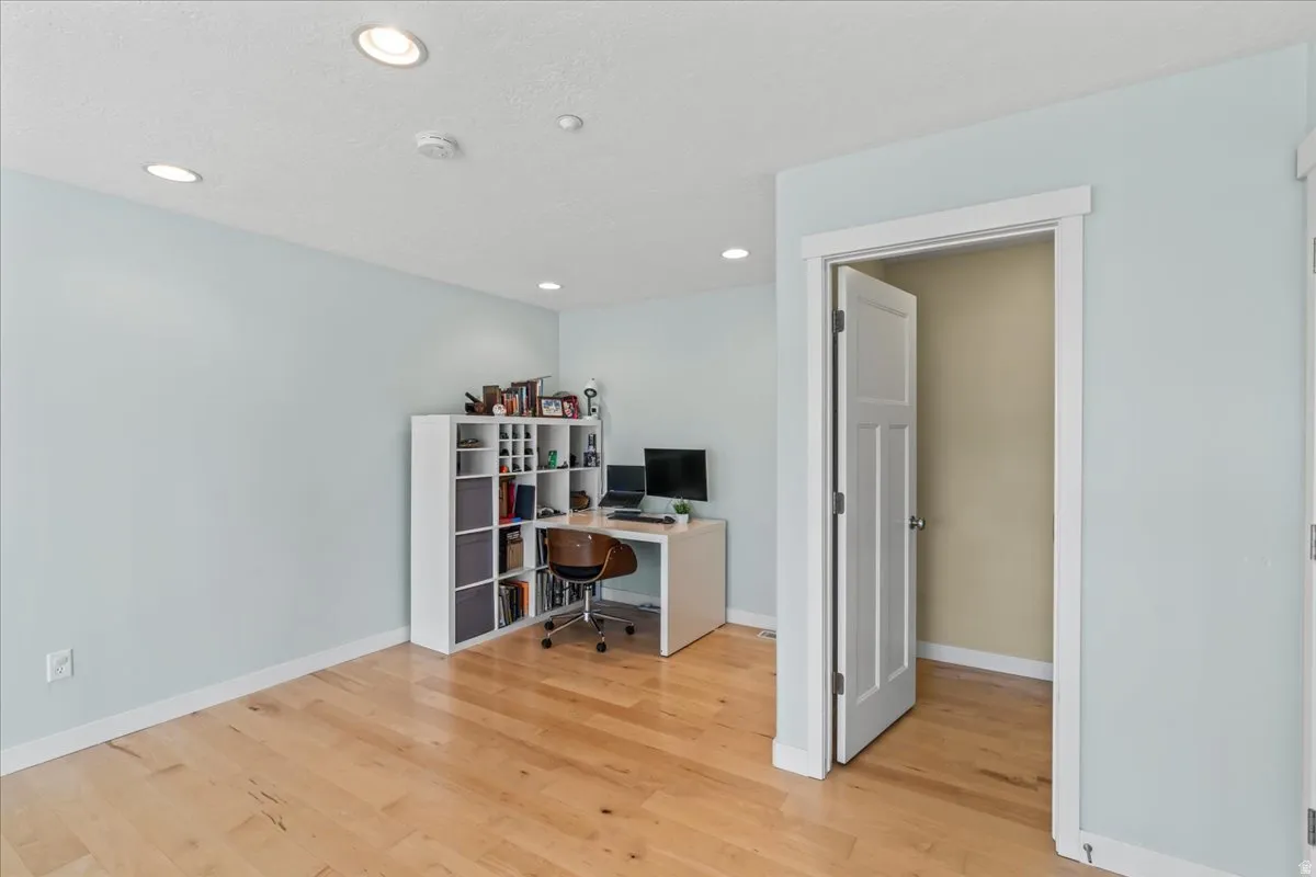 Bright interior space with light wood-finish flooring, recessed lighting, and a crisp white trim package