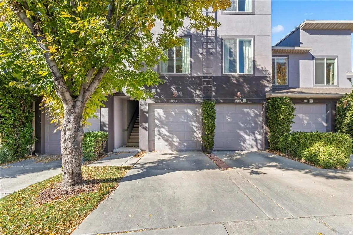 Contemporary multi-story exterior featuring stucco siding and multiple windows