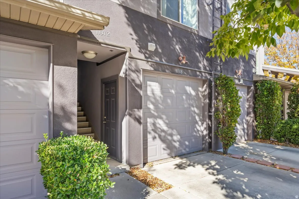 Entrance is up the stairs to the left of the garage.