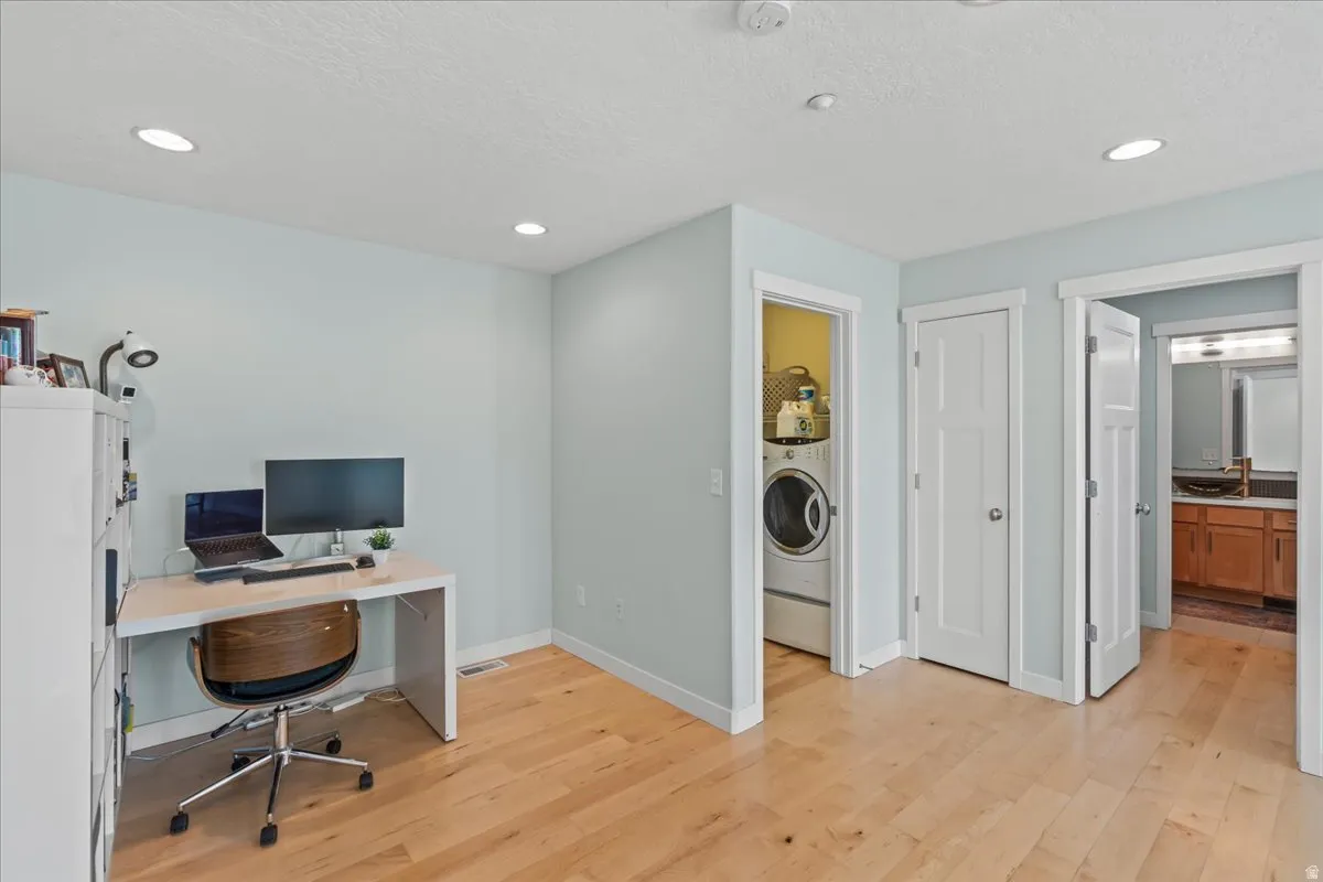 Light wood-finish flooring complements the pale blue walls and white trim