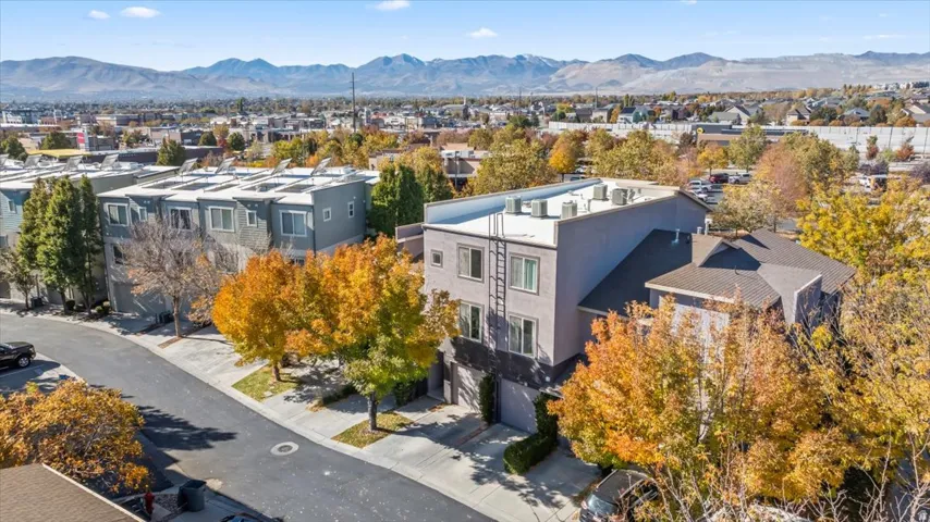 Modern multi-story building featuring a flat roofline and a neutral-toned facade