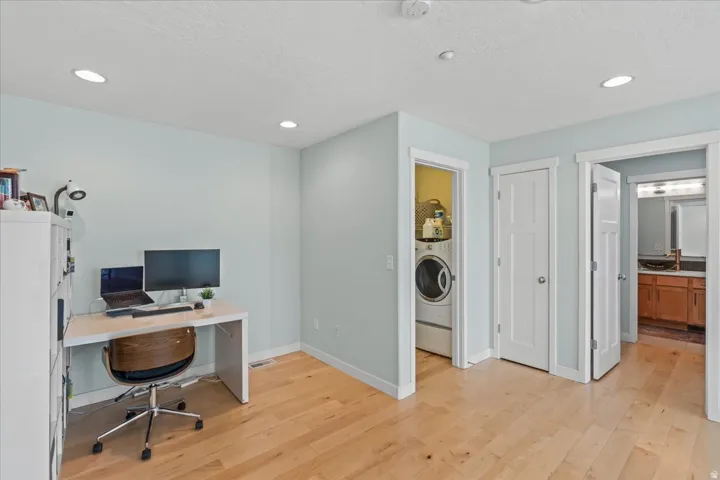 Light wood-finish flooring complements the pale blue walls and white trim