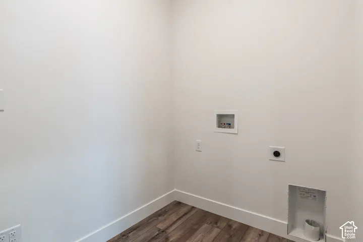 Wood-finish flooring with white baseboards, and a white wall finish