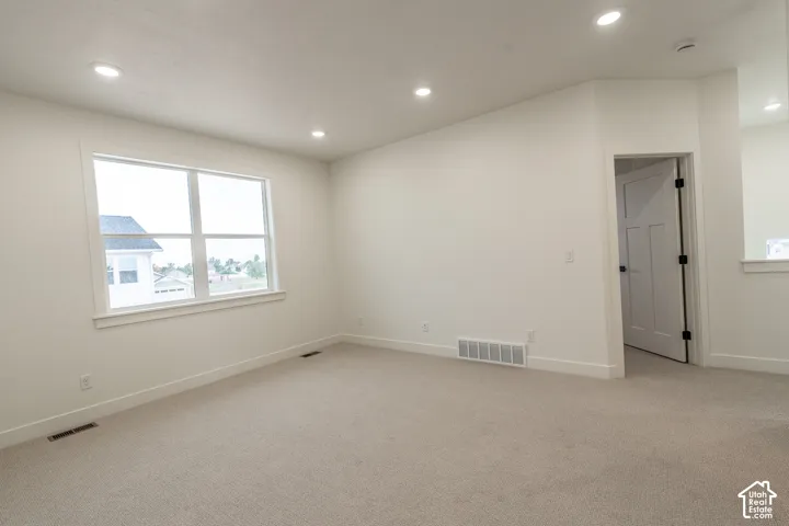 Recessed lighting and a large window with white trim