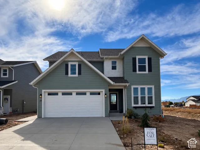 Two-story residence featuring light green siding and white trim