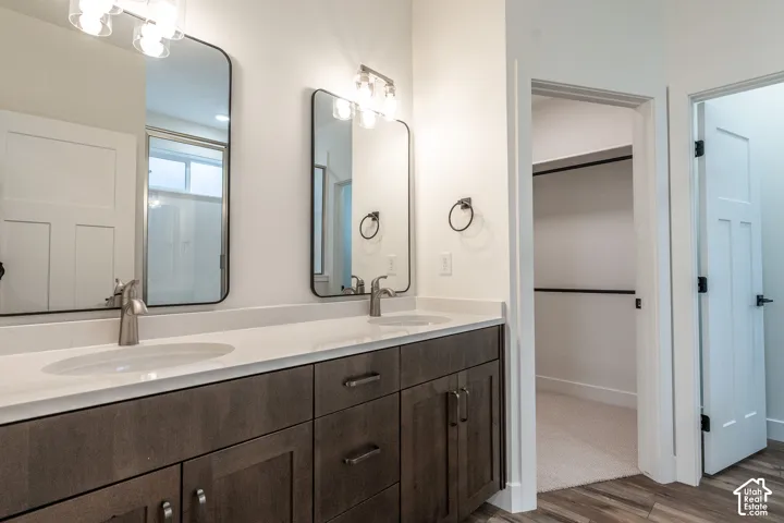 Dual vanity with integrated sinks, white countertops, and dark wood-finish cabinetry