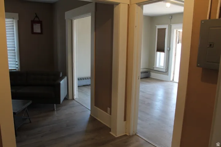 Interior featuring wood-finish flooring, neutral wall tones, and white trim throughout