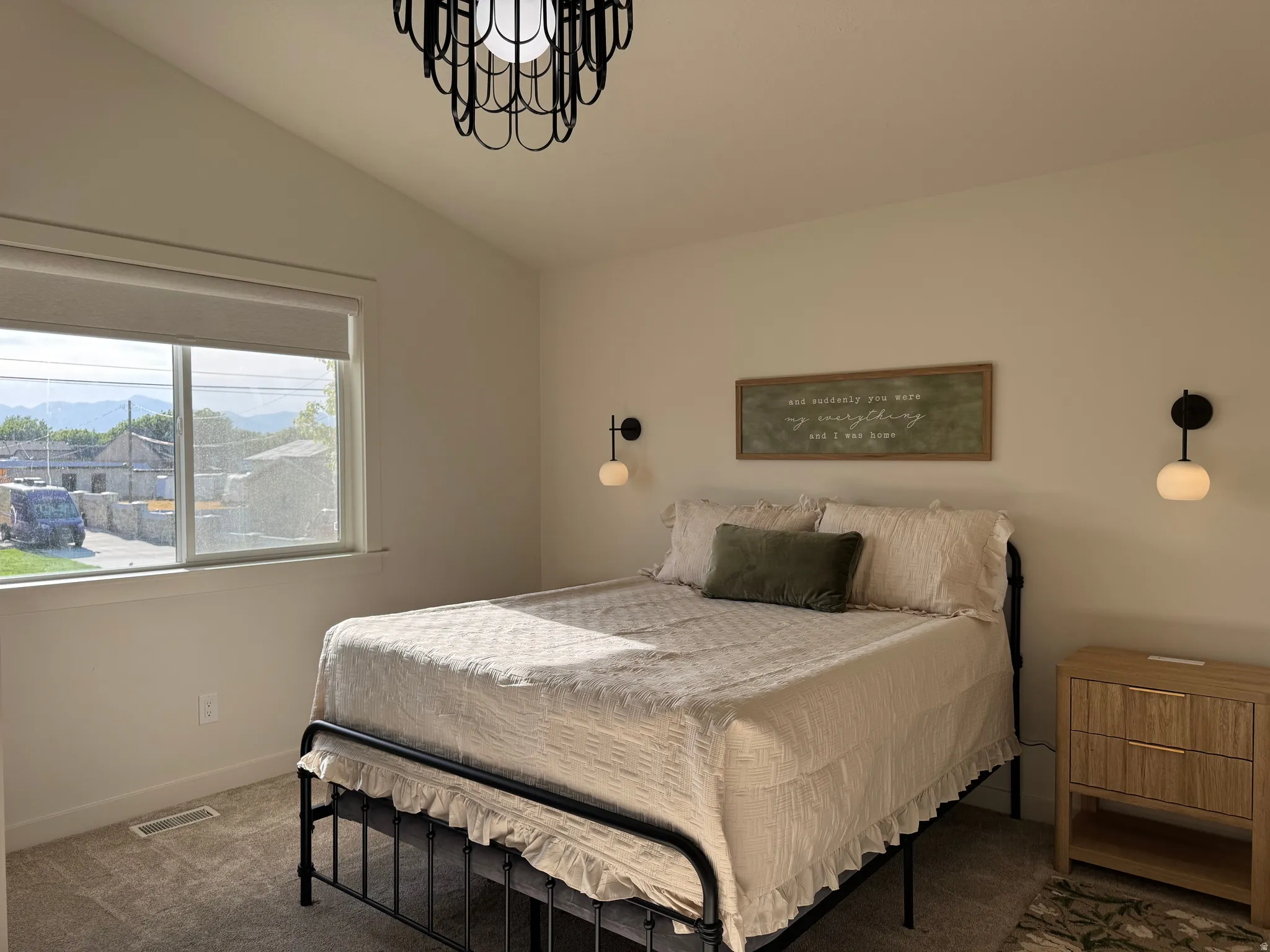 Spacious room featuring a single large window, vaulted ceiling, and recessed lighting