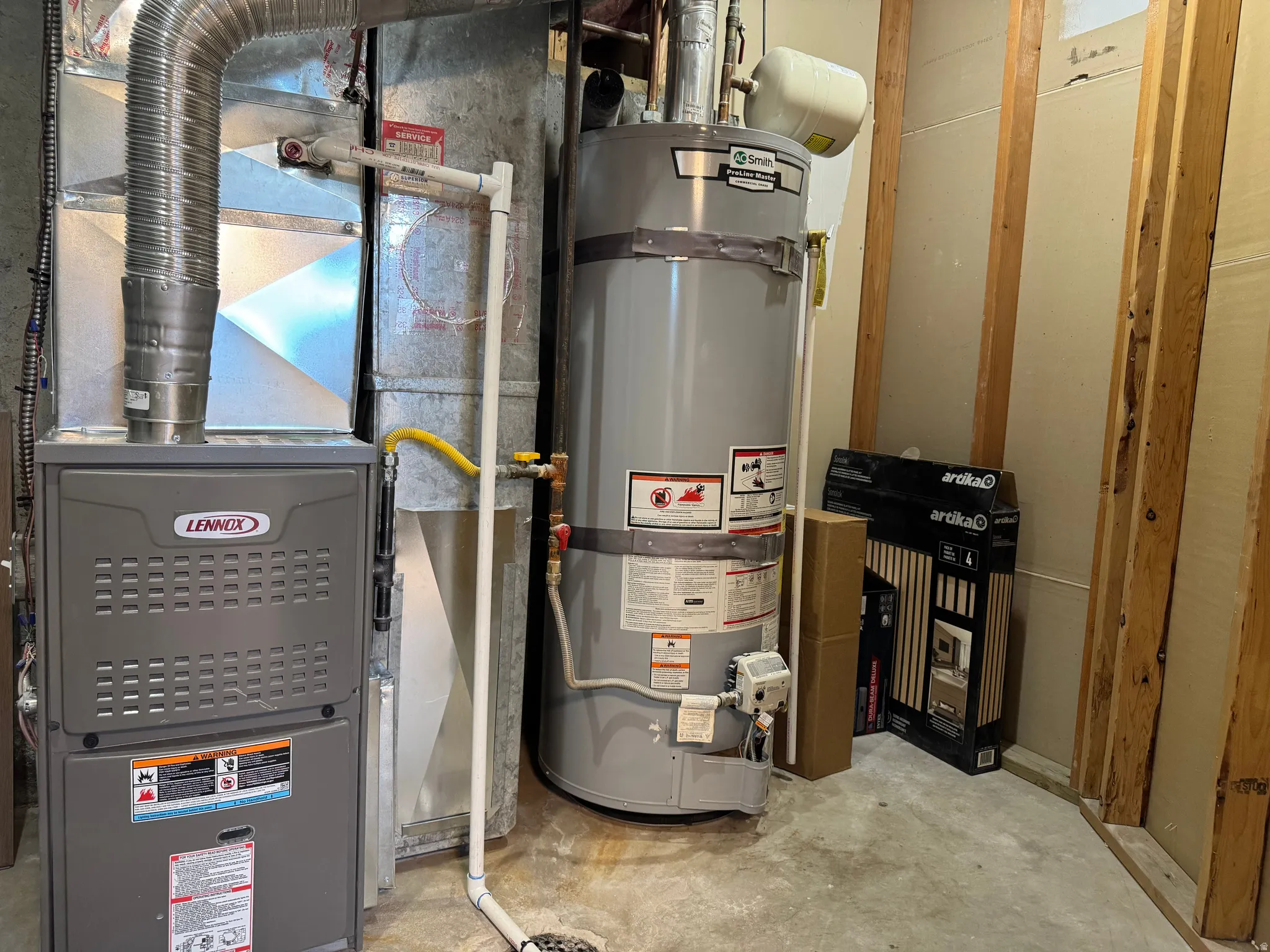 Lennox furnace and Smith water heater installed on a concrete floor