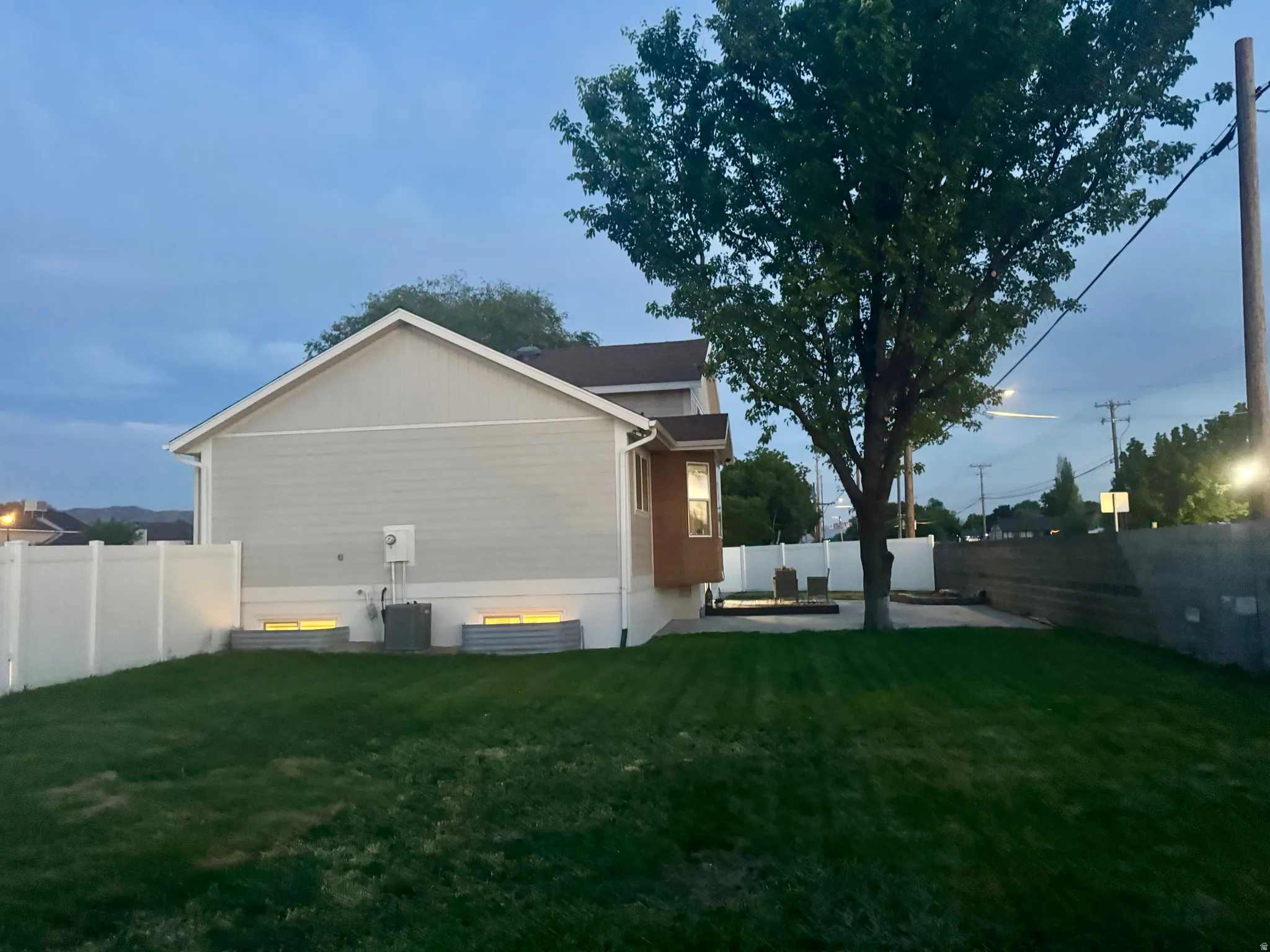 Expansive grass lawn with a spacious patio area