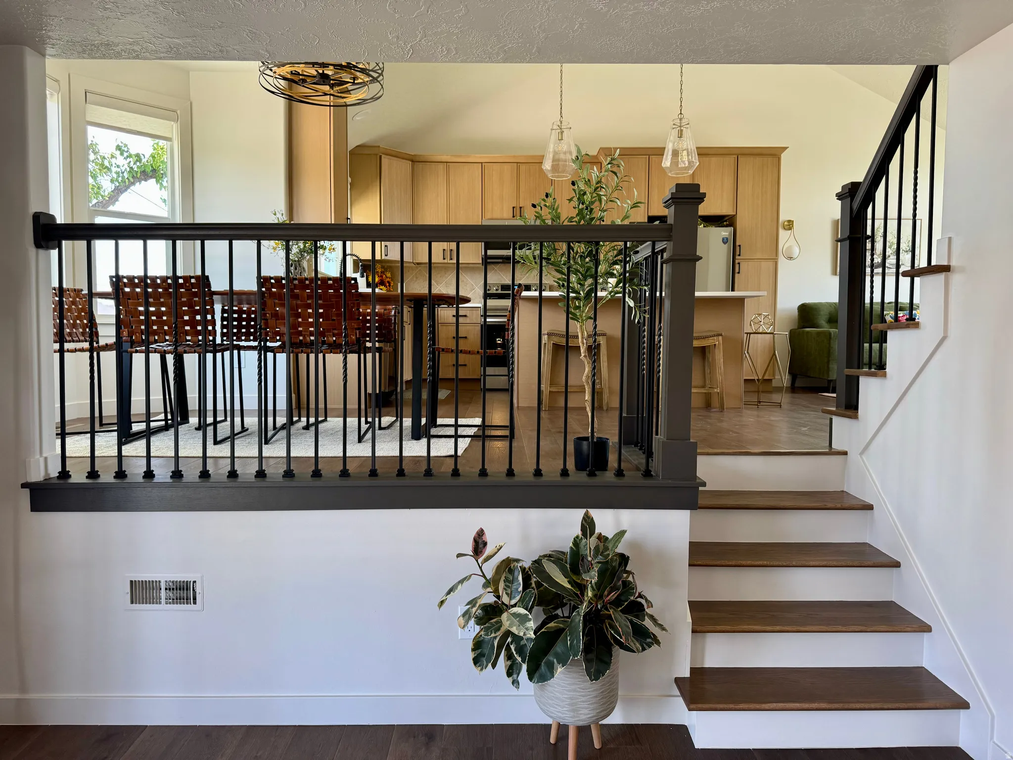 Staircase featuring dark wood treads and white risers, complemented by a dark-stained newel post and balusters