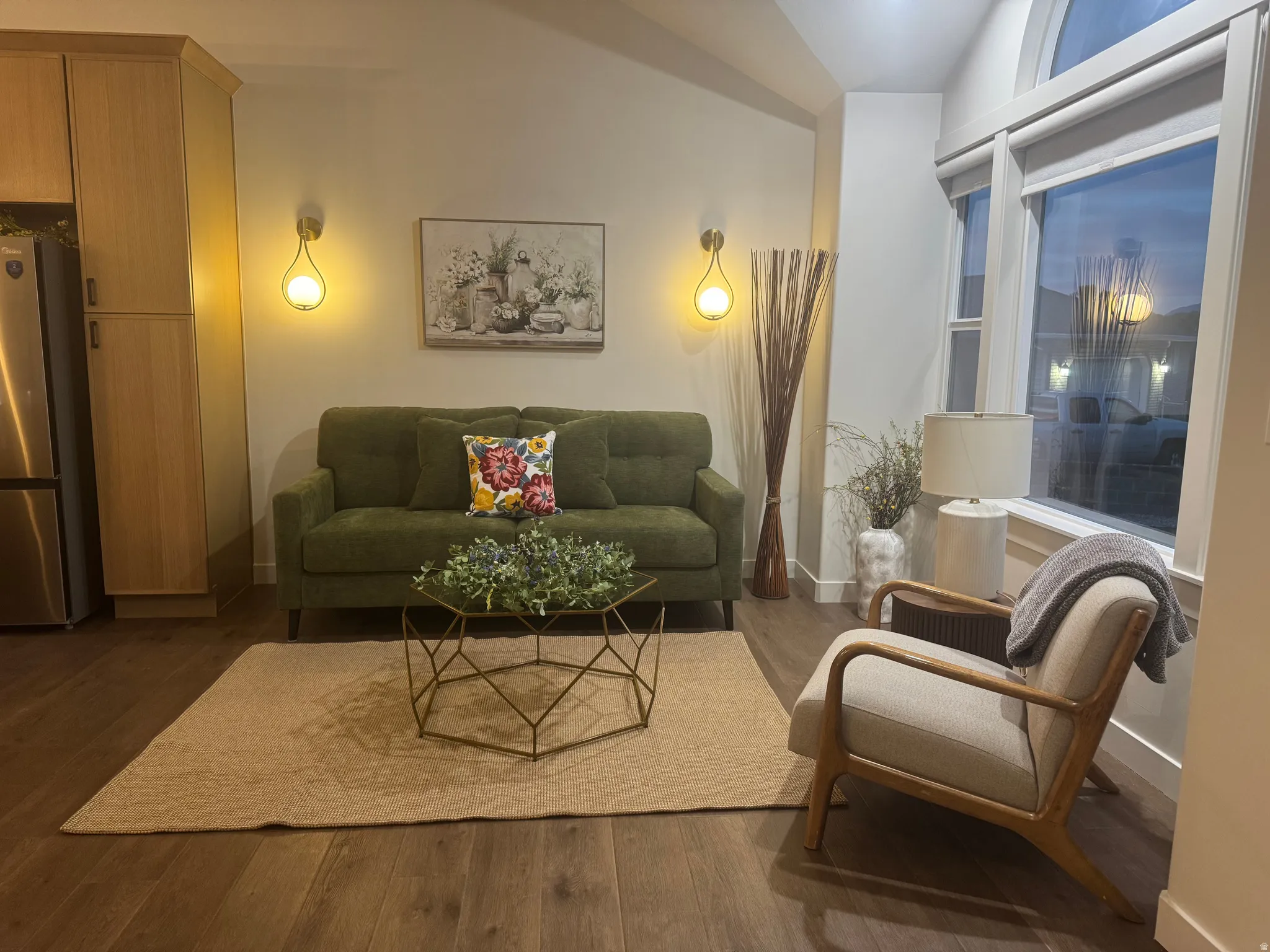 Living area featuring wood-finish flooring, a vaulted ceiling, and recessed lighting