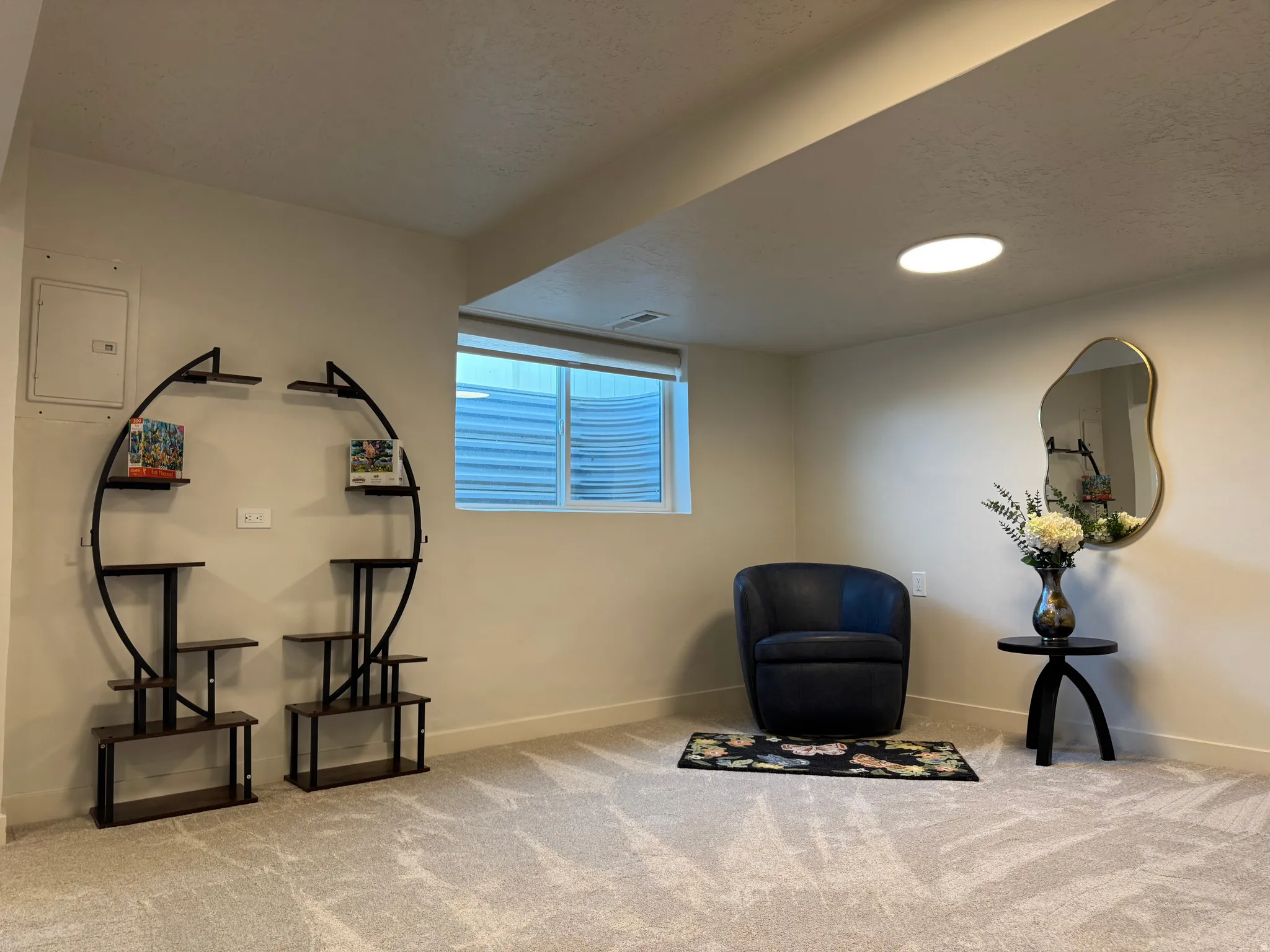 Spacious room featuring neutral carpeting, a large window, and recessed ceiling lighting