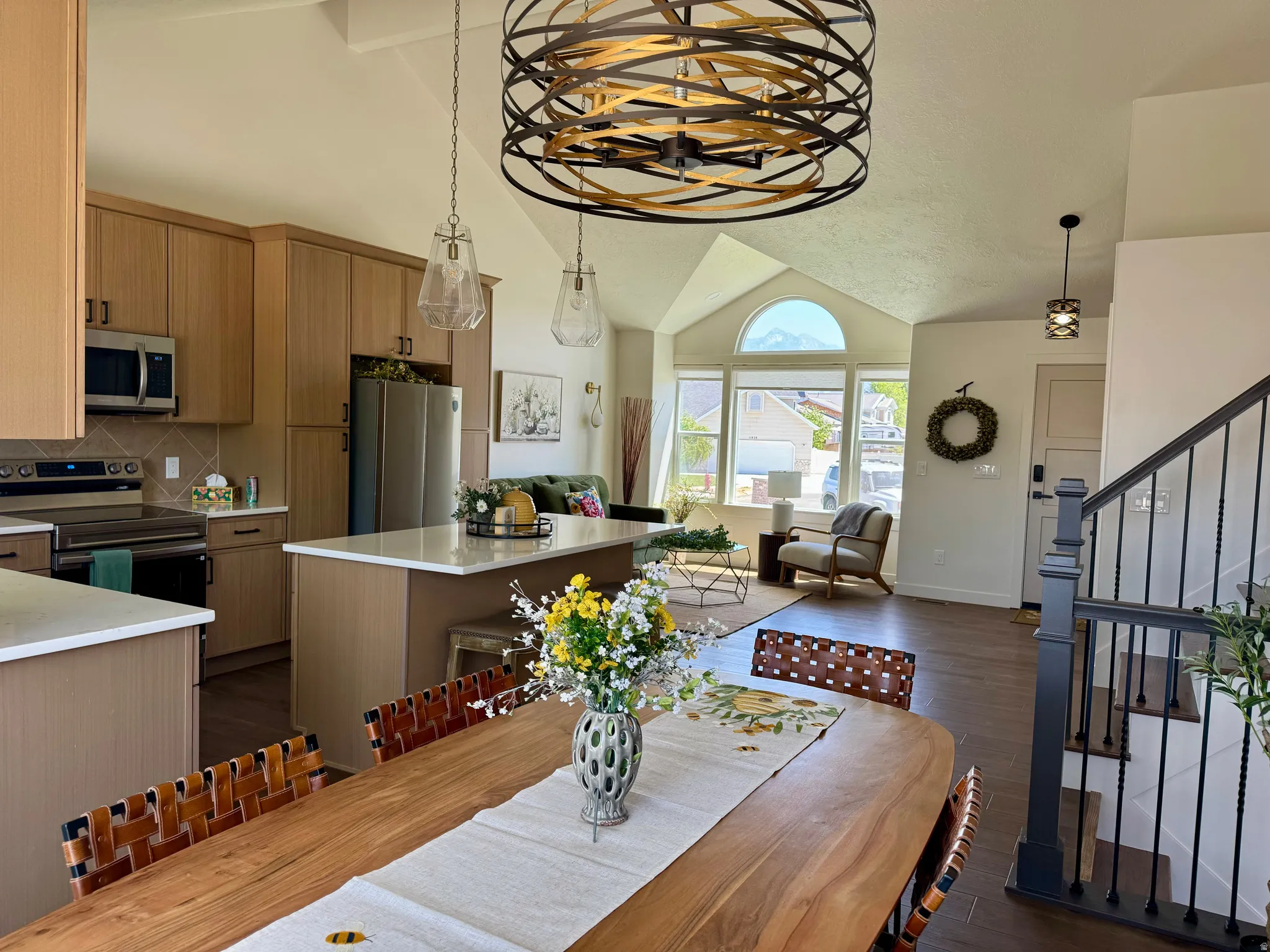 Open-concept living area featuring a kitchen, dining space, and sitting area