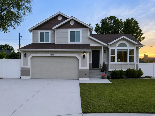 Two-story residence featuring light gray siding with dark brown accents