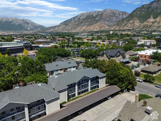 Multi-story residential buildings featuring grey shingle roofs and multiple balconies