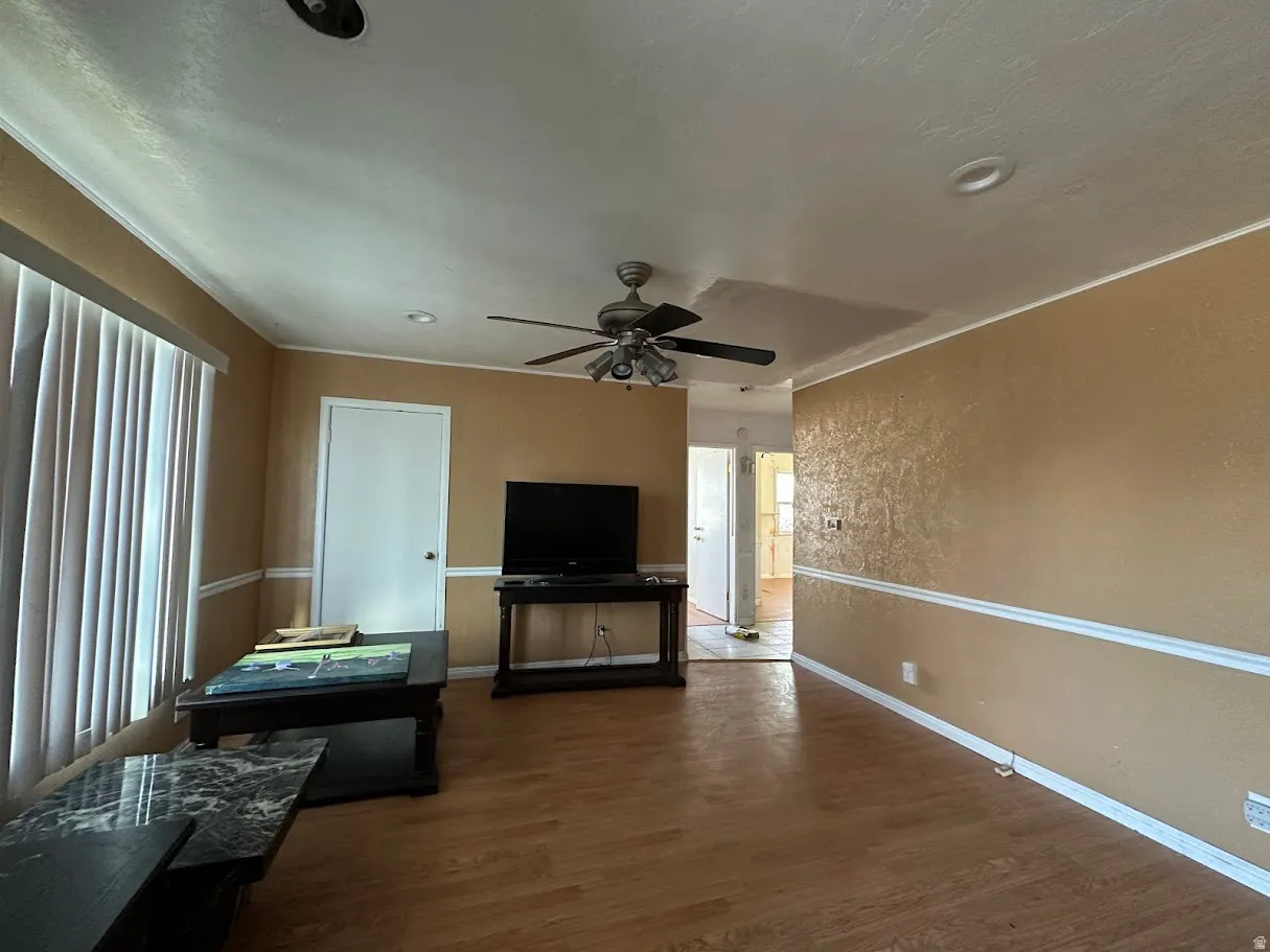 Spacious interior featuring wood-finish flooring, recessed lighting, and a ceiling fan