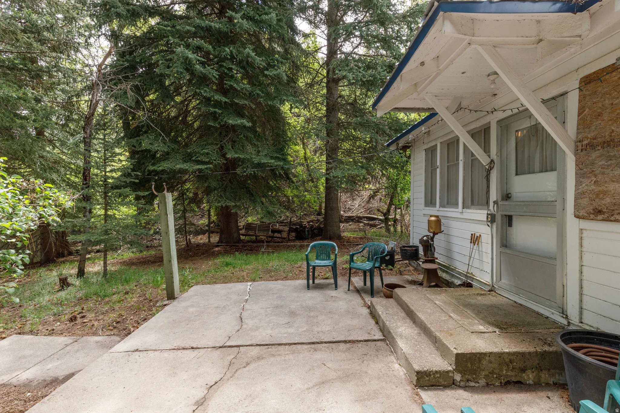 Wooded exterior featuring a concrete patio and a covered porch entry