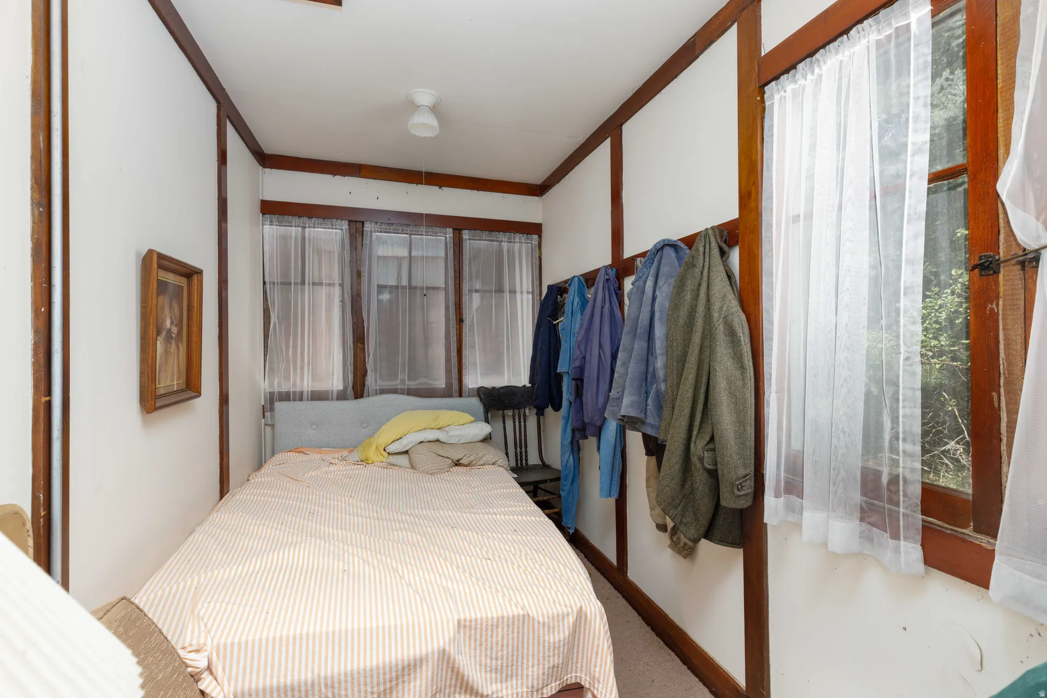 Compact interior space featuring white walls with dark wood trim accents