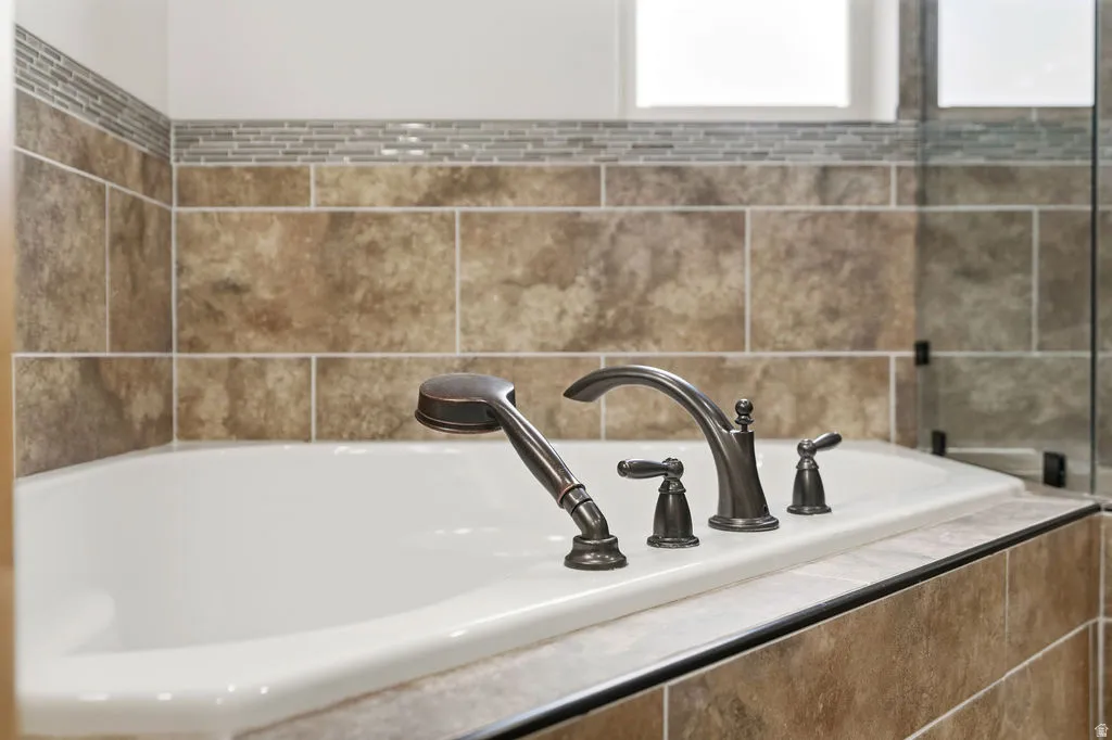 Deep soaking tub with oil-rubbed bronze fixtures