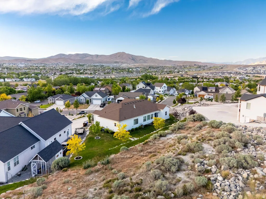 Expansive neighborhood with diverse residential architecture and mountainous backdrop