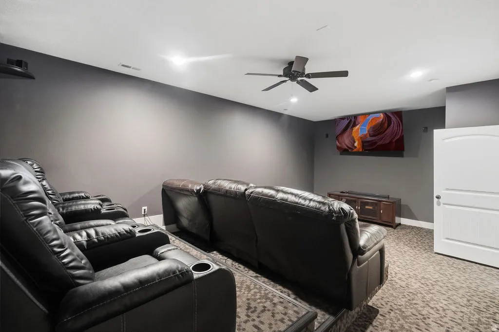 Dedicated media room featuring dark gray walls and textured carpeting