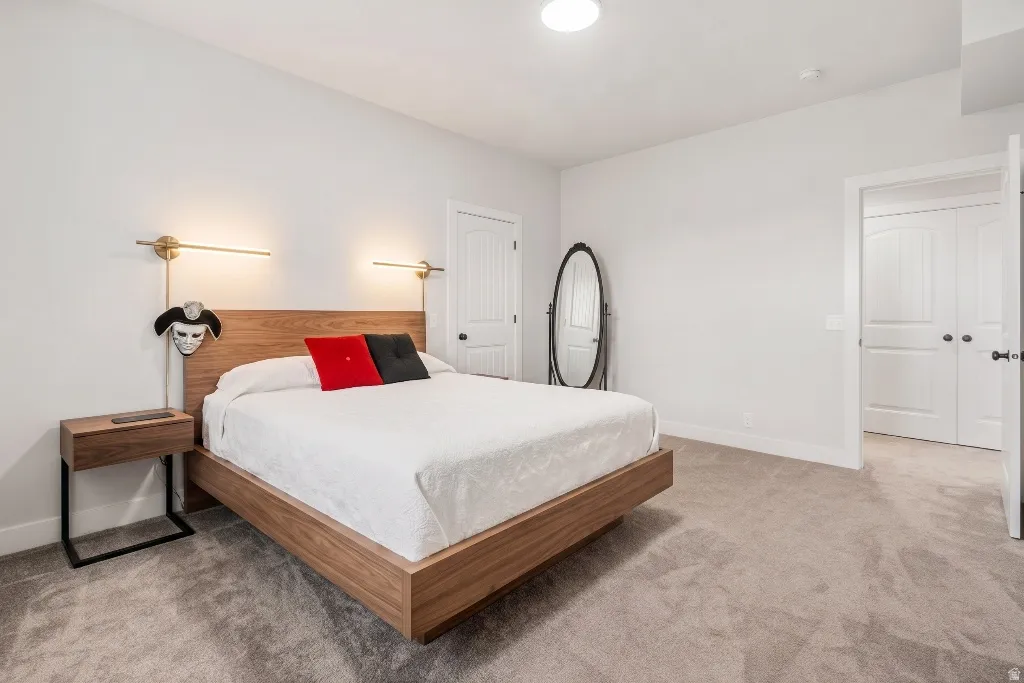 Bedroom featuring plush carpet flooring, white walls, and a recessed ceiling light
