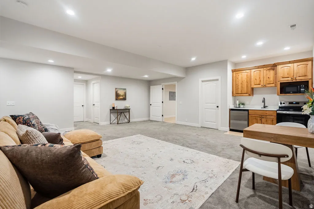 Open-concept lower level featuring recessed lighting and gray carpeting