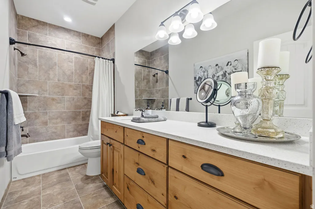 Bathroom featuring a light wood vanity with matte black hardware, a white countertop, and an integrated sink with a chrome faucet
