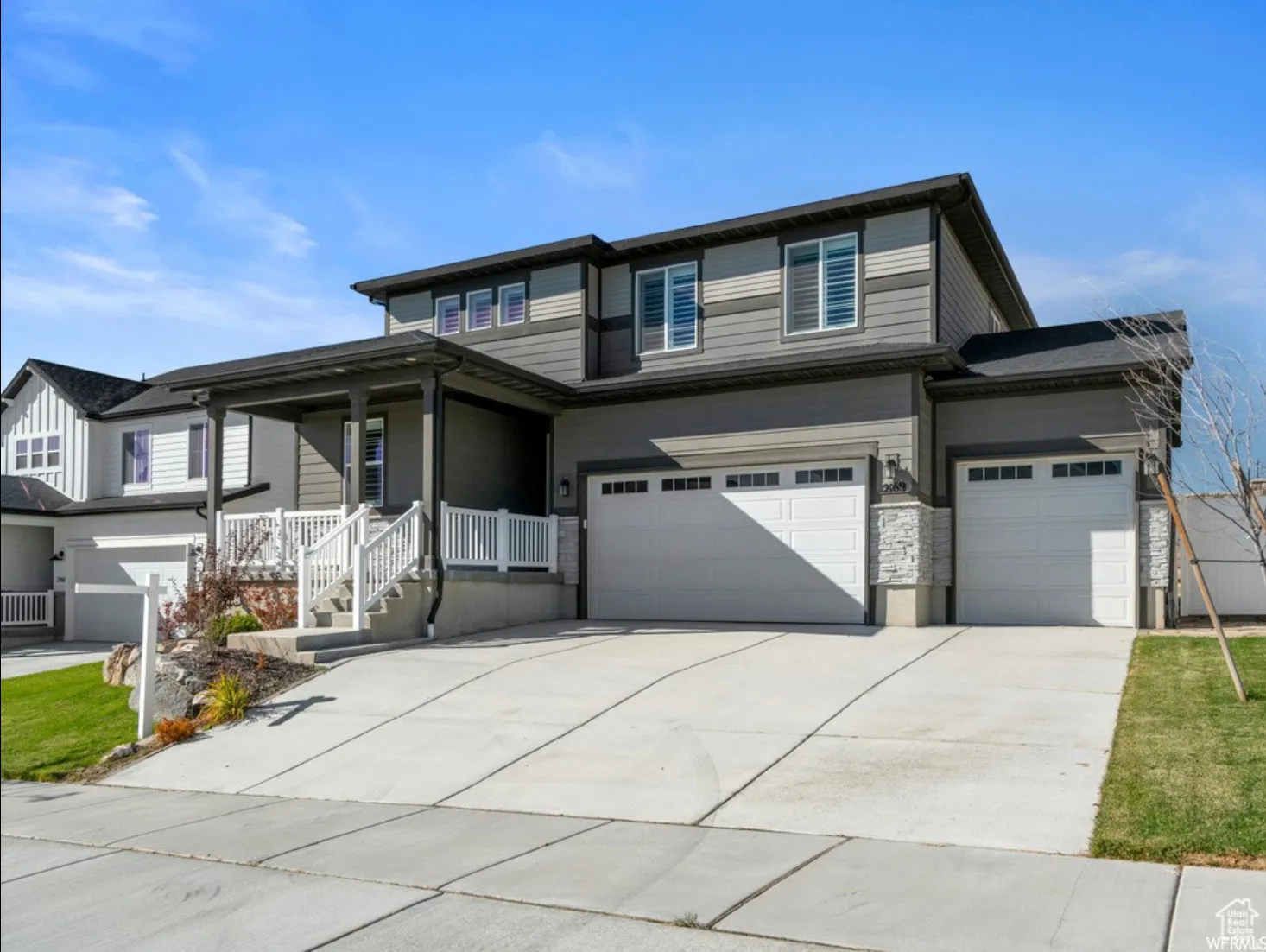 Contemporary exterior with multi-toned siding and a covered front porch
