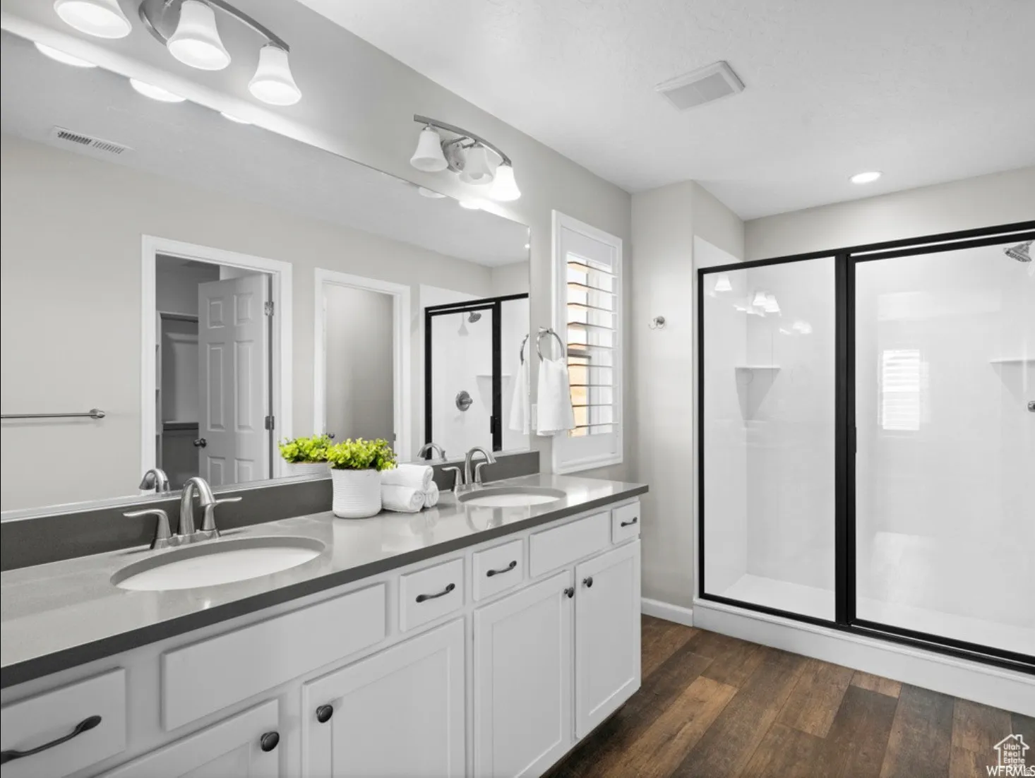 Double vanity with quartz-finish countertop and undermount sinks